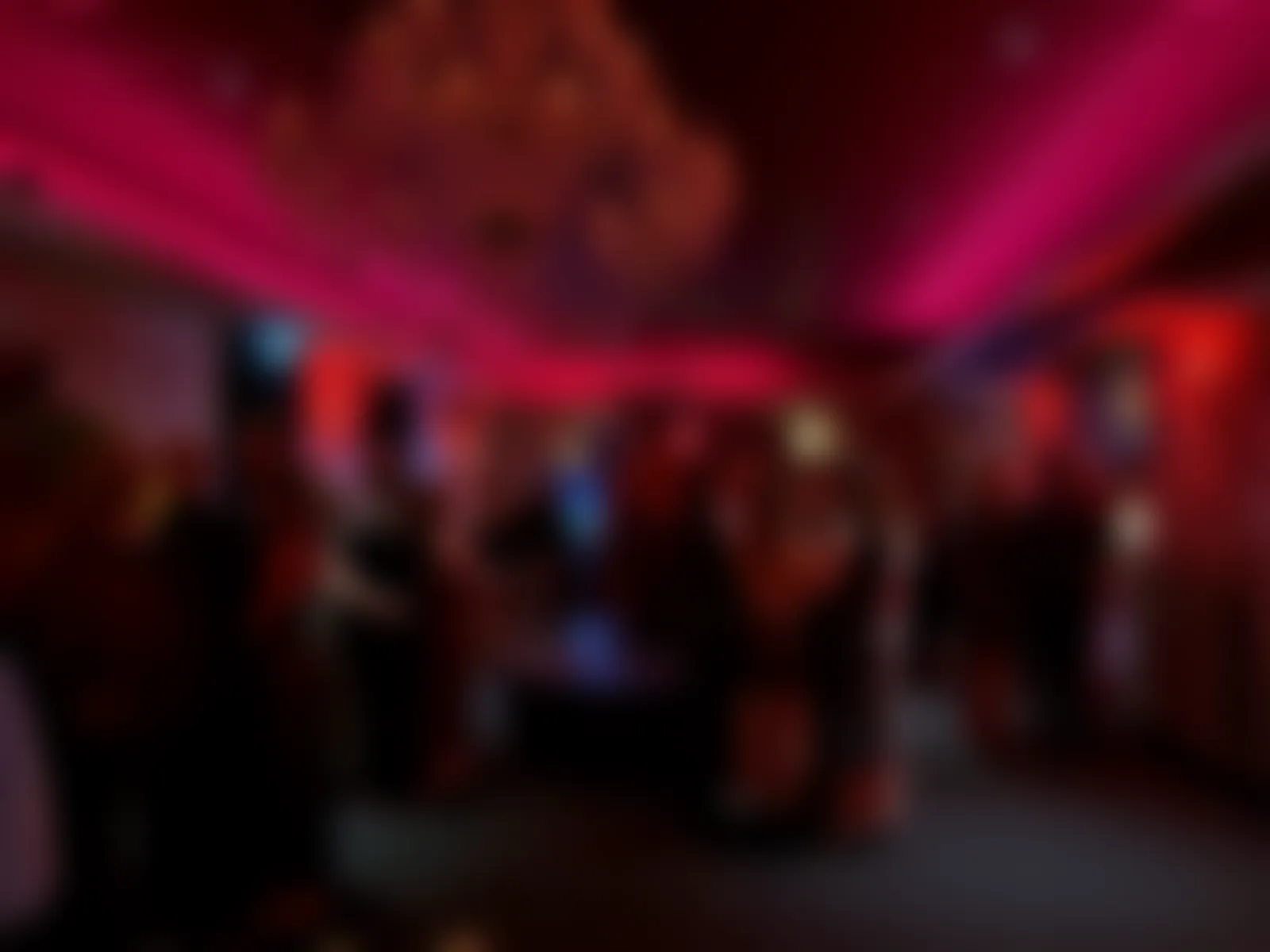 Guests gathering in the lounge under the chandelier, softened for privacy