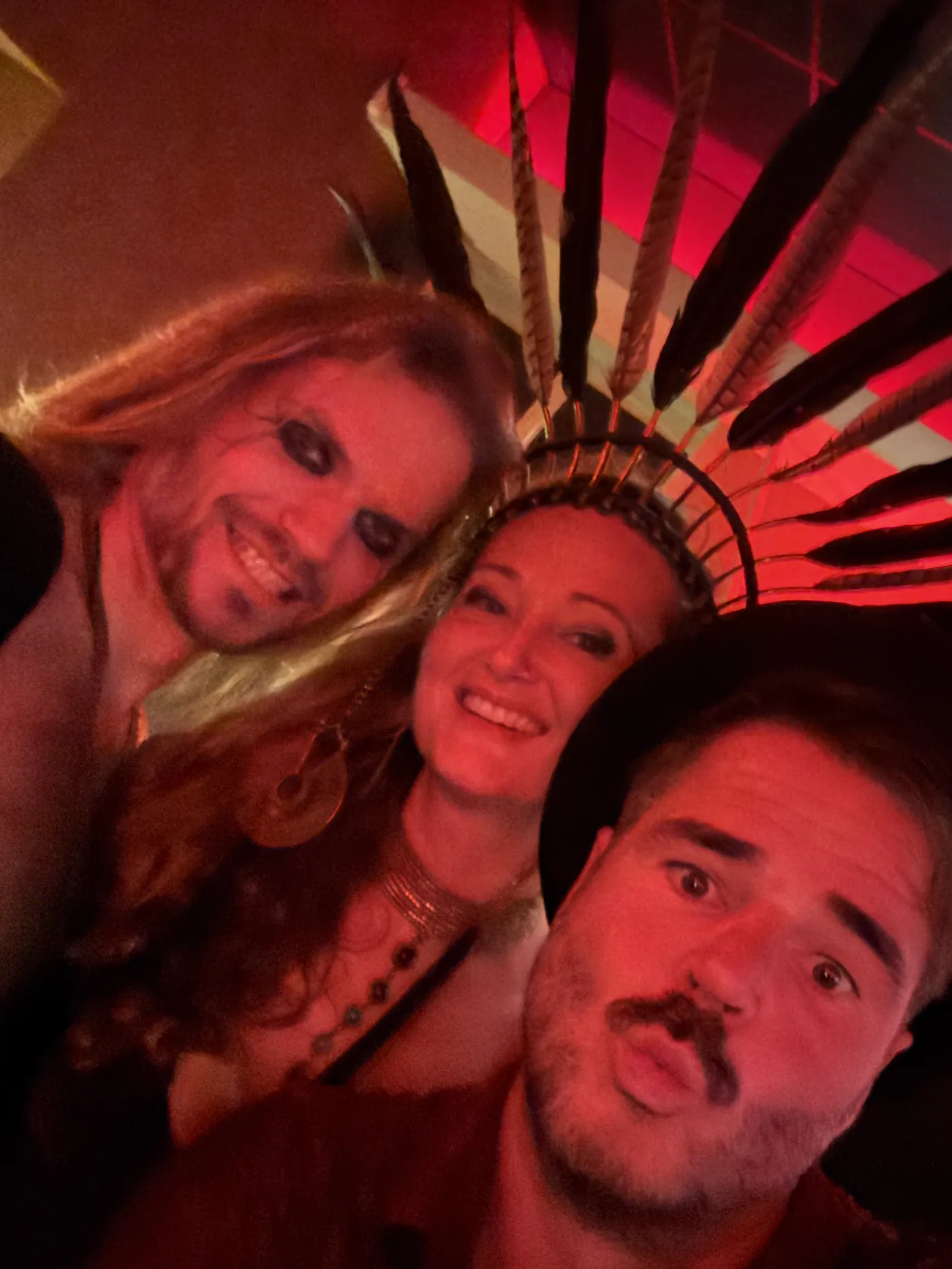 Hosts of The House of Eros taking a selfie in red light